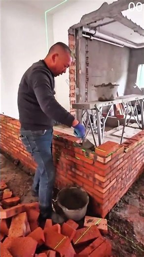 Stitching bright orange and striped blue fabric together using sewing machine