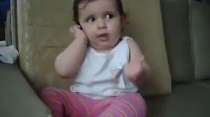 Watch this adorable baby talk into a cell phone like a pro