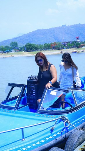 Women Enjoying a Scenic Boat Ride on a Lake
