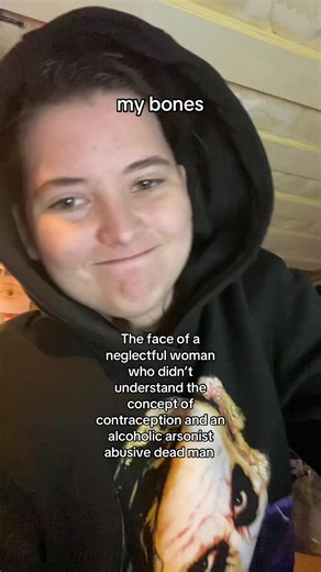 VD: white boy called Jamie wearing a black joker hoodie with good up, smiling at the camera, sat on the bottom bunk of a bunk bed, the text on the screen says “The face of a neglectful woman who didn’t understand the concept of contraception and an alcoholic arsonist abusive dead man”, the text at the top of the screen is the captions, end of VD #fyp #trend #parents
