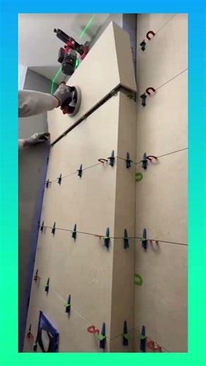 Installing large wall tiles with precision, using hidden fixing techniques for a clean