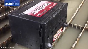 Powerful pressurised waterjet slices car battery in half