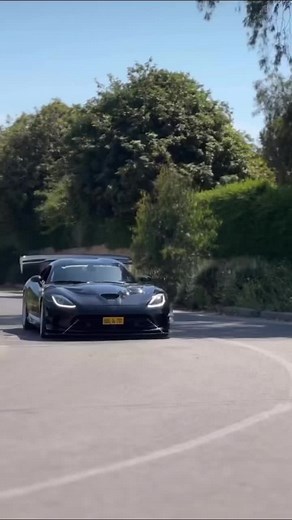High-Performance Black Sports Car Cruising Urban Streets