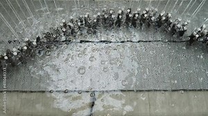 Artificial waterfall jets flows down from ceiling or decorative fountain in interior. Thread fountain string well movement water wall Indoor design of waterfall in interior office building glass home Stock Video