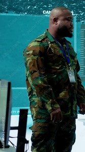 Vertical Video Military personnel operate advanced systems in a command center, focusing on surveillance and data analysis to protect national security. Soldiers trained to manage information warfare