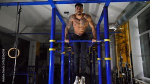 Strong african sportsman doing exercises on horizontal bar at modern gym. Muscular afro american man muscling up indoor. Young black athlete training at fitness club. Sport and active lifestyle