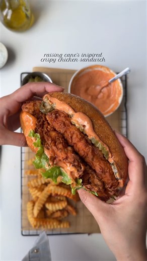 Iram Mansoor on Instagram: "Raising Cane’s inspired crispy chicken sandwich 🥪 Ingredients: Ingredients 2 lb boneless chicken breast Oil for frying For the wet batter: 1 cup all purpose flour Salt and pepper to taste 1 tbsp Cajun seasoning 1 tbsp garlic powder 1 tbsp onion powder 1 tbsp baking powder 3/4 cup water ( less or more to make thick batter) For the dry batter: 1 cup all purpose flour Salt and pepper to taste 1 tbsp garlic powder 1 tbsp onion powder 1 tbsp Cajun seasoning For the raisin