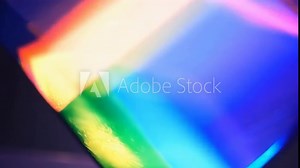 Holographic pyramid is projecting futuristic image consisting of rainbow colored lights, concept for innovation, future technology and augmented reality