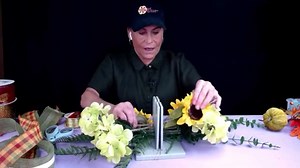 No Hot GIue Needed: Easy Fall Door Swag Tutorial… In this tutorial, Sandy Sandler, the creator of Bowdabra, will guide you through the process of crafting a beautiful Fall door swag without the use of hot glue. You'll work with vibrant flowers, greenery, and two different ribbons to create a stunning piece that enhances your autumn decor. Join Sandy as she shares her creative tips, and be sure to subscribe for more inspiring DIY projects and live tutorials every week! Materials: 2 different gree