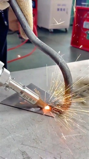 A Close Up View of an Industrial Tool Cutting Metal with Bright Sparks and Intense Heat
