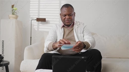 Virologist explaining colleagues and patients how use protective mask online. Portrait of health professional in white gown speaking in video conference of preventive treatment in influenza epidemic