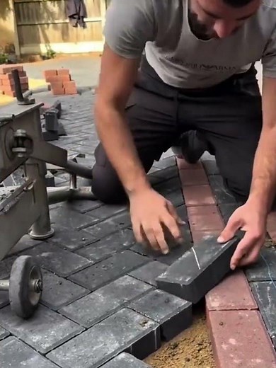 Cutting a paving stone using a manual press to install on a solid floor surface #pavingblocks