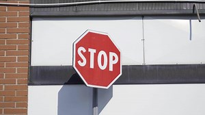 Red stop road sign in the sun
