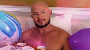 GMA’s Sam Champion ‘ambushes’ shirtless husband in bed in new video