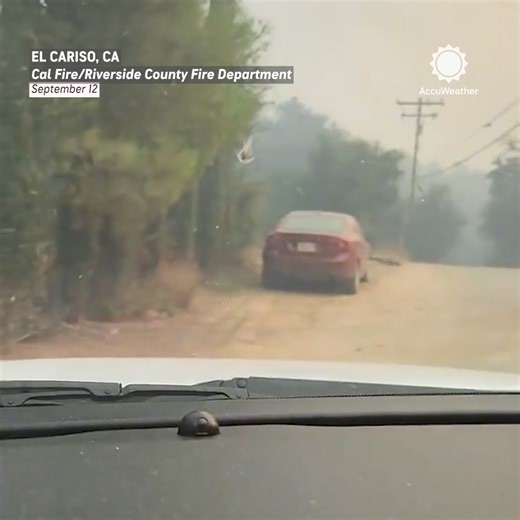 Amid the chaos of the Airport Fire, a firefighter rescues a man and his dog from the rapidly spreading flames. | AccuWeather