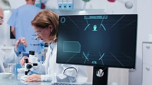 Woman looking through a microscope - Free Stock Video