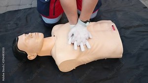 Medical specialist is demonstrating a technique of a cardiopulmonary resuscitation on a medical training