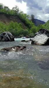 White Water Rafting Adventure - Video Montage. People in Inflatable Rafts Paddling Through River Rapids. Whitewater Rafting Aerial View. Active Vacations. Drone POV of Picturesque River Canyon.