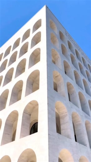 Palazzo della Civiltà Italiana in Rome, Italy - captured by @anlinsh • The Palazzo della Civiltà Italiana, also known as the Colosseo Quadrato, is a building in the EUR district in Rome. It was designed in 1938 by three Italian architects: Giovanni Guerrini, Ernesto La Padula, and Mario Romano. The building is an example of Italian Rationalism and fascist architecture. The design draws inspiration from the Colosseum with rows of arches. According to legend, the structure’s six vertical and nine 