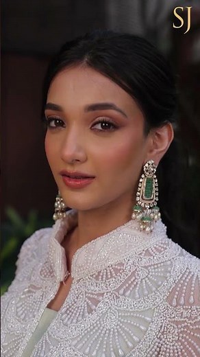 When she smiles, it shines in her glimmering gems.