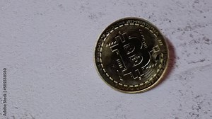 Slow motion Bitcoin gold coin spins then falls. Bitcoin mining trading concept. BTC golden money spinning around. Worldwide virtual internet Cryptocurrency or crypto digital payment system. Digital