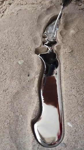 Carving Designs in Wet Sand with a Red Glove