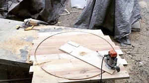 Andrew is using a plunge router & circle cutting jig to cut out a top for our Melissa Round Table. It took three simple steps to get to this point: First, he screwed the base of the plunge router to a piece of plywood. Next, he measured the radius of the circle. Lastly, Andrew attached the plywood at that radius and then after a few passes, voila! You too can follow these simple steps for your next round table project! #harpdesignco | Harp Design Co.