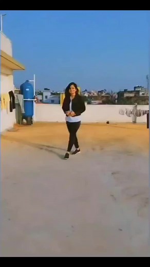 Dynamic Rooftop Dance Performance in Stylish Outfit