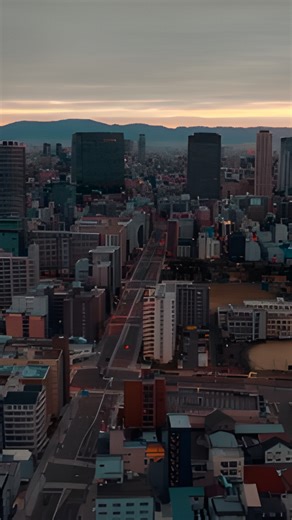 Looking down on a cloudy city with a bustling street scene