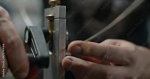 Luthier uses fretbender to set the fret wire radius, preparations for fretting at the guitar maker workshop, 4k 60p Prores HQ