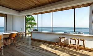 Modern kitchen with ocean view, white counter, wooden floor and bar stools.