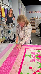 Sandy's trimming up this beautiful customer quilt that Brenda just took off the longarm! #deesweresewcreative #weresewcreative #berninalingarm #longarm #longarmservice #cltquiltshop | We're Sew Creative