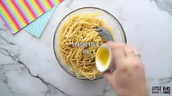 Rainbow sensory play with spaghetti is perfect for the younger kiddos! https://littlebinsforlittlehands.com/rainbow-spaghetti/ | Little Bins for Little Hands