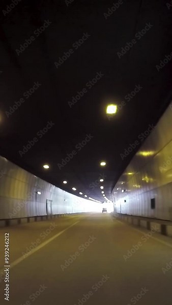 Car driving through the tunnel from the car passenger point of view. Scene. Vehicle moving through the tunnel, driver view.