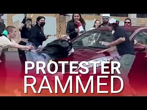 Protester run over by moving car as fed-up LA drivers have had enough of disruptive riots