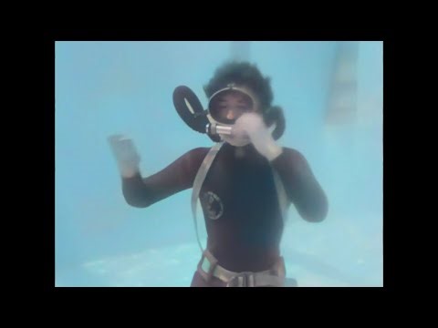 Female Diver is Diving with Rubber Wetsuit