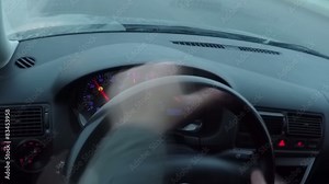 The driver behind the wheel. Driving a car viewed from inside.