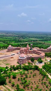 The central temple building is shaped like the Sanskrit symbol “ॐ (Om)”. ￼The complex is spread over about 250 acres. The peak / shikhara is approx 135 feet tall. The structure is supported with around 2000 pillars. There are 108 rooms/residential units, which are part of the OM-shaped layout. ￼ The temple complex is meant to accommodate 1,008 idols of Lord Mahadev and 12 Jyotirlingas. A lake forms part of the design (representing the crescent moon in the OM symbol), and the “Bindu” point is mad