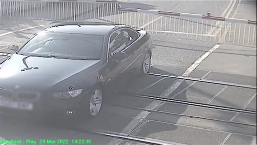 Tense moment driver gets stuck on level crossing as a speeding train approaches