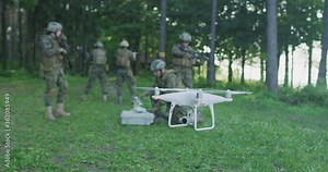 Army engineer using drone to monitor enemy and complete military action