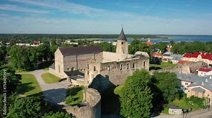 Aerial 4K video from drone to Haapsalu Castle in the background the town of Haapsalu and the Baltic Sea coast. Haapsalu, Estonia, Baltic States, Europe
