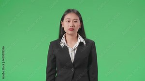 An Angry Asian Business Woman Scolding While Standing On Green Screen In The Studio