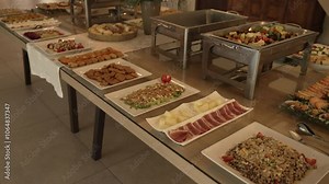 Buffet table with an assortment of appetizers and main dishes, set for a formal event
