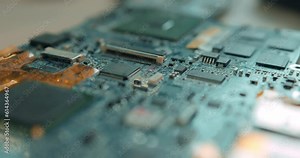 blurred slow motion electronic control panel, Repairs laptop (pc, computer) motherboard. Install of equipment (cpu). Disassembled details fixing during laptop repair at computer shop. focus on details