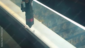 Laser cutting pattern in plastic mold. Laser cut pattern in plastic. Sewing factory. Laser cutting of patterns in garment production.