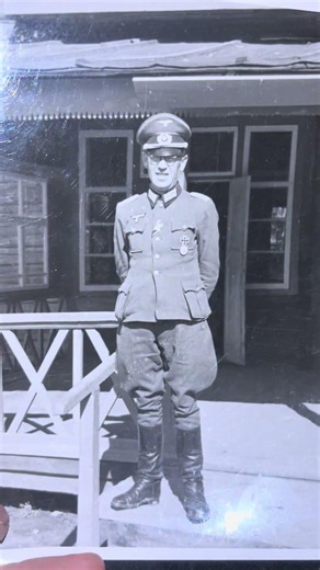 German soldier with silver wound badge IKC2 and 1 class and another button ribbon on a porch WW2