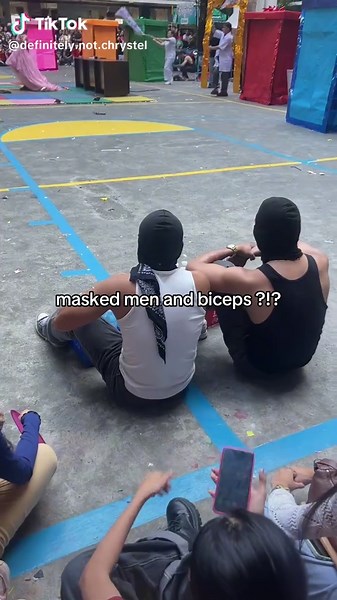 Masked Men Flexing Biceps: A Display of Strength