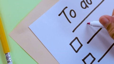 clip-4010864771-person-uses-pink-marker-write-homework-on