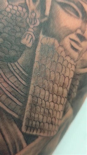 The tattoo in this image depicts Gilgamesh, the legendary king of Uruk from the ancient Mesopotamian epic poem, *Gilgamesh*. We welcome and serve you like family. We are a family owned business and we are 100% Thai. There are no foreign investors or partners. If you like our work and are truly willing to support Thai people. Please think of us. Find a great tattoo shop in Phuket If you need a job that suit your requirements, think about us. @Goldeninktattoo ✏️ Design, fix, add on, tattoo over sc