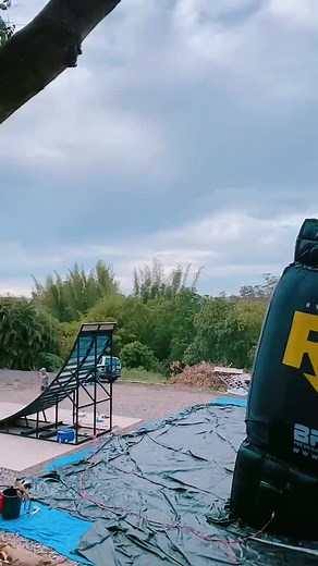 BMX Bike Stunts on Inflatable Ramp in Outdoor Setting